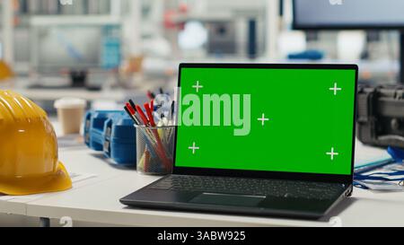 Green screen laptop used to adjust photovoltaics factory system parameters. Mockup notebook in office used for optimizing energy supply in solar panel manufacturing plant Stock Photo