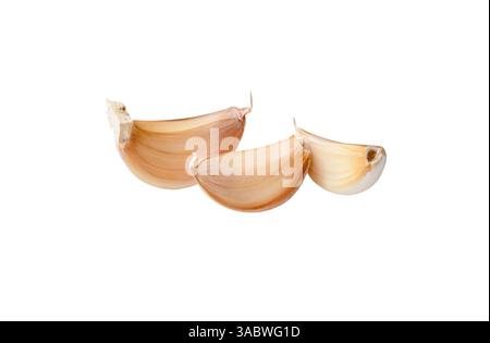 Side view of three unpeeled garlic cloves or pieces in stack is isolated on white background with clipping path. Stock Photo