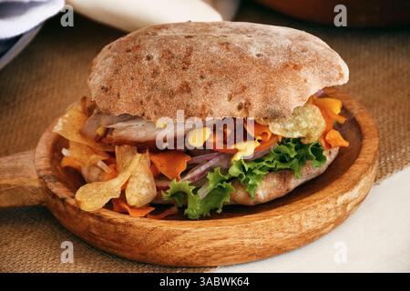 Pan chapla with chicharrón, a traditional breakfast from Ayacucho, Peru