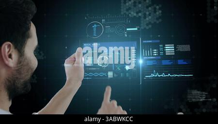 Using futuristic digital tablet, man exploring new technology in virtual environment Stock Photo