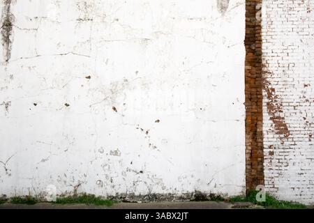 Damaged exterior wall with exposed brick Stock Photo