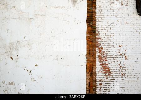 Damaged exterior wall with exposed brick Stock Photo