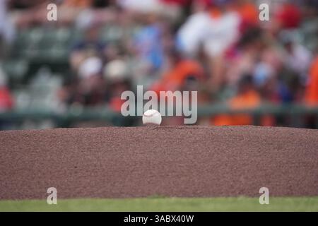 A baseball on the dirt of a pitching mound between innings of a baseball game. Stock Photo
