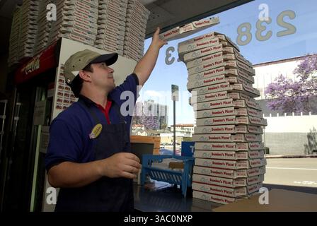 (Published 05/03/2003, C-1) Domino's Pizza manager Steve Ray stacks pizza boxes in a downtown store.--Laura Embry/Union-Tribune Stock Photo