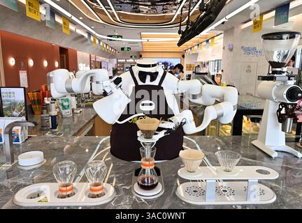 AI Coffee Master robot crafts beverages for customers at a café in Rongdong District, Xiongan New Area, Hebei Province. Xiong'an,China.2nd April 2025. Xiongan's Rongdong District in the north China's Hebei Province, showcases AI Patrol Robots, Driverless Tech & Smart Innovations in Futuristic Urban Hub, April 2, 2025. Credit: Zhai Yujia/China News Service/Ģ����ý Live News Stock Photo
