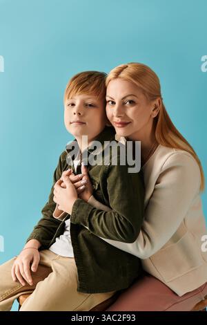 A loving mother embraces her son while they share a warm smile, highlighting their close bond. Stock Photo