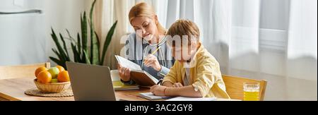 A mother guides her son through his homework while they enjoy a sunny afternoon in their kitchen. Stock Photo