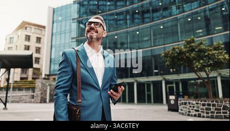 Walking, thinking or man in city with phone, appointment or ideas in urban town for opportunity. Mature, financial advisor or consultant with mobile Stock Photo