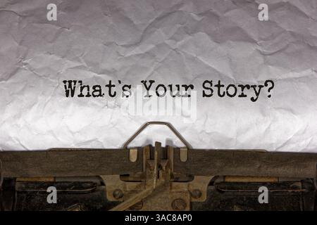what is your story close up of a phrase being typed and centered on a sheet of paper on an old vintage mechanical typewriter. text message Stock Photo