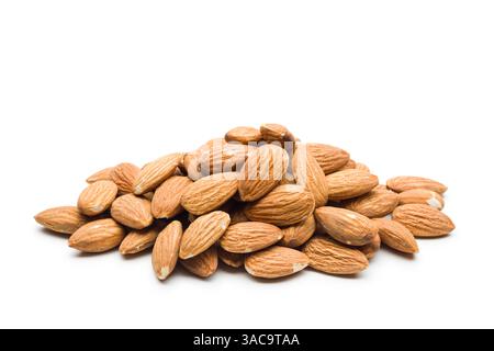 Heap of almonds on white isolated background. Stock Photo