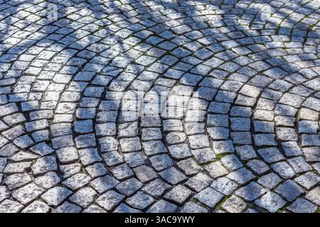 City center road surface made from granite setts laid in curved arcs - Tours, Indre-et-Loire (37), France. Stock Photo
