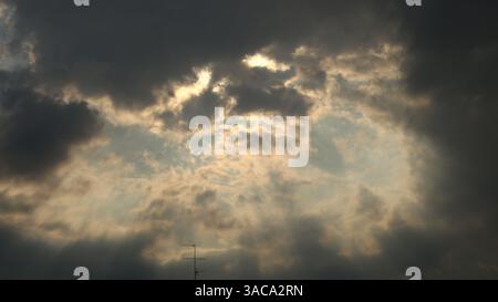 Dramatic Dark Clouds with Sunlight Breaking Through Stock Photo
