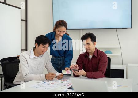 Collaborative UX UI Review Session. Designers evaluate concepts together, discussing the next steps for their projects. Stock Photo