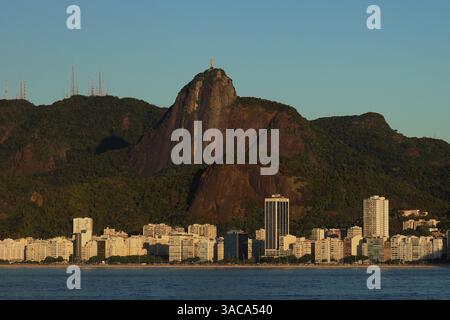 Rio de Janeiro, Brazil - Skyscrapers of Ipanema Beach at sunrise with the Christ the Redeemer statue on top of Corcovado mountain in the distance Stock Photo