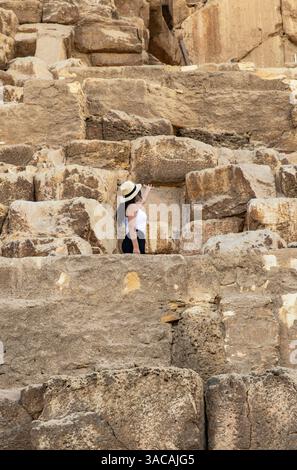 Witness a tourist touching the Great Pyramid of Keops in Giza, Egypt ...