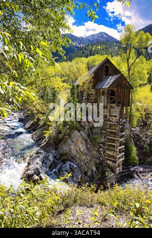 crystal mill river waterfall aspens blue sky clouds fast moving water Stock Photo