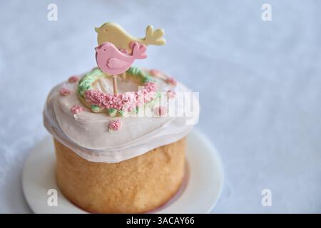 Resplendent, springtime happiness overflows from this beautifully baked Kulchichi Easter cake, adorned with a delicate bird and floral frosting, evoki Stock Photo