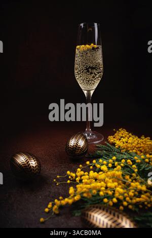 Easter celebration with champagne, mimosa, and golden eggs Stock Photo