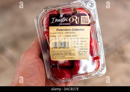 Cagliari, Italy - April 27, 2024: Plum tomatoes in plastic package container grown on Sardinia island, Italy Italian fresh vegetable Stock Photo