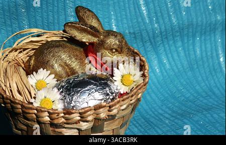 Happy Easter Golden Bunny with Red Bow and Silver Egg Stock Photo
