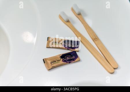 Warsaw, Poland - April 4, 2023: White glo whitening toothpaste, disposable wooden bamboo toothbrush for tooth cleaning on white background Stock Photo