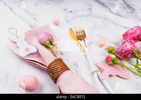 Easter Table Setting with Pink Napkin and Roses Stock Photo