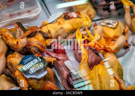 Cagliari, Italy - April 27, 2024: Whole chicken rabbit animal meat at Mercato San Benedetto food market on retail fridge shelf display Stock Photo
