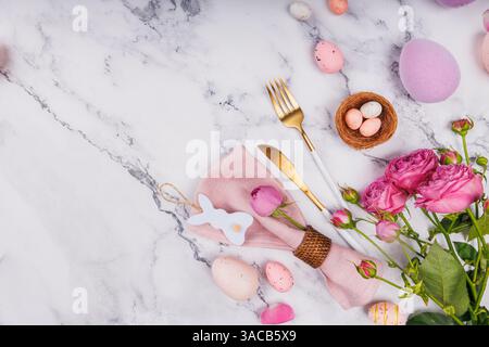 Easter Table Setting with Roses and Gold Cutlery Stock Photo