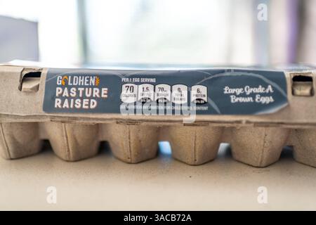Roseland, USA - February 4, 2025: Goldhen Aldi chicken eggs dozen in cardboard container, free range pasture raised food macro closeup Stock Photo