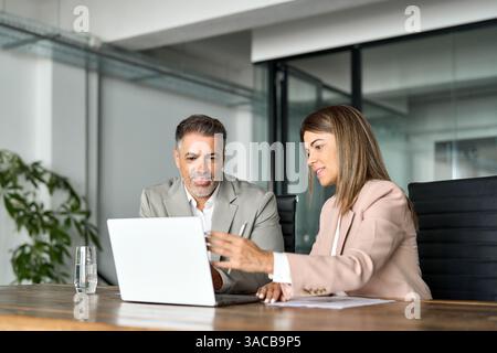 Two professional business executives working together at office meeting. Stock Photo