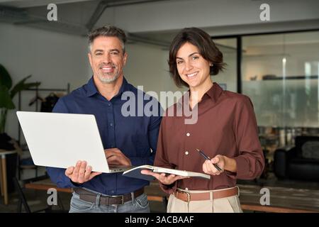 Two happy business executives team people posing in office. Portrait. Stock Photo