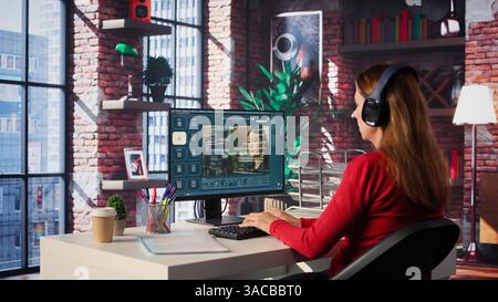 Software developer at home office coding on desktop using AI powered script, building an interface and implementing programming language algorithms. Engineer uses text to code. Camera B. Stock Photo