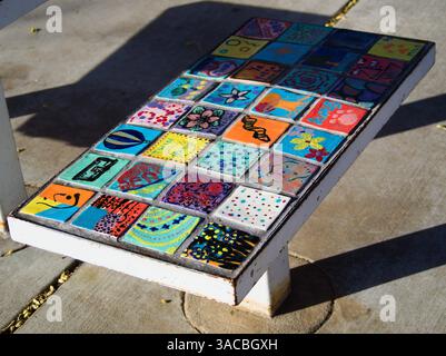 Colorful Mosaic Art on Bench with Personalized Decorative Tiles Outdoors Stock Photo