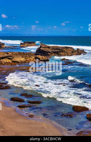 Sunset at rocky shoreline of Love Beach. Stock Photo