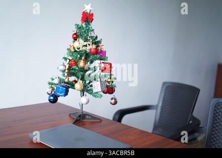 christmas tree and decorations on the table at office Stock Photo