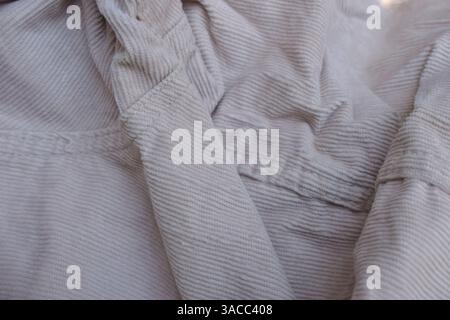 Folded Off White Denim Shirt Fabric Texture Close Up Background Stock Photo