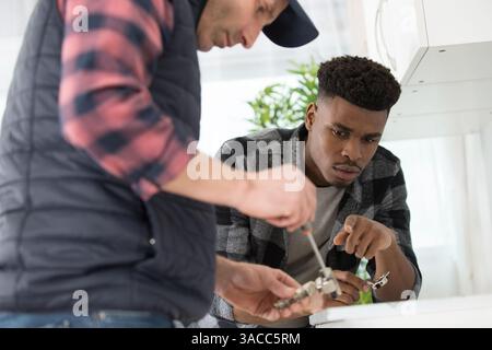 two men fitting a new kitchen Stock Photo