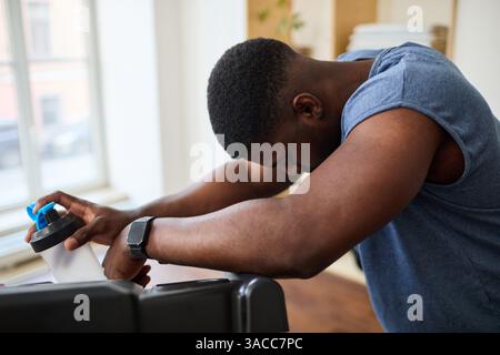 African American Man Resting after Workout at Home Stock Photo