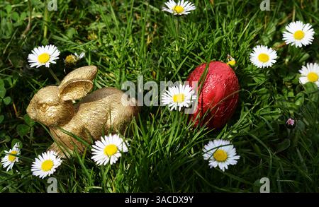Happy Easter with Golden Bunny and Flowers Stock Photo