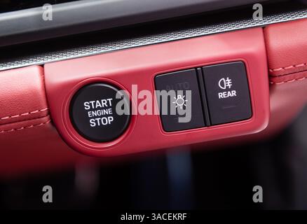 Car dashboard with focus on engine start stop button Stock Photo