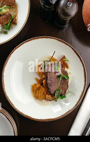 beefsteak with vegetables and sauces Stock Photo