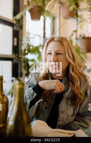 Woman leaning forward, engaged in conversation Stock Photo