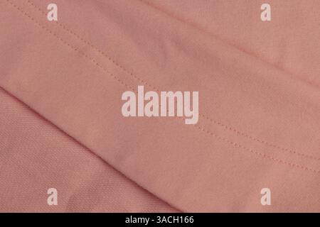pink fabric from which clothes are sewn, fabric made of natural materials with seams with threads, details of pink clothes Stock Photo