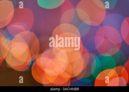 Colorful abstract bokeh lights in soft focus creating a vibrant and dreamy atmosphere. Stock Photo