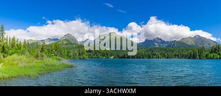 Beautiful lake forest in Tatra mountains, sunny blue sky clouds. Amazing summer nature panoramic view. Stunning hiking scene, picturesque background Stock Photo