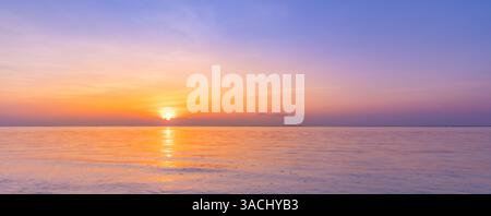 Wide aerial panorama of seascape sunset reflecting in calm sea. Copy space ocean view, romantic inspire sunrise background. Amazing nature beach scene Stock Photo