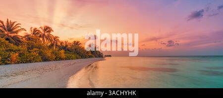 Maldives sunset sky shore landscape. Discover tropical paradise with serene beaches calm sea, stunning golden horizon with coco palm trees panorama Stock Photo