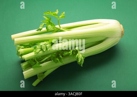 Fresh celery on dark green background. Top view Stock Photo
