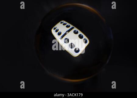Double 6 domino in a crystal ball with dark background Stock Photo