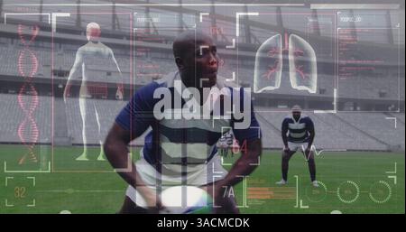 Image of digital interface with medical data processing over rugby players Stock Photo